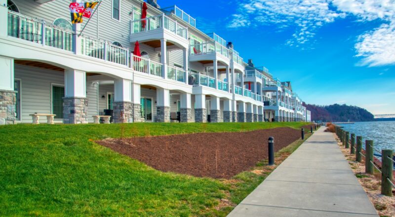 a row of apartment buildings next to a body of water